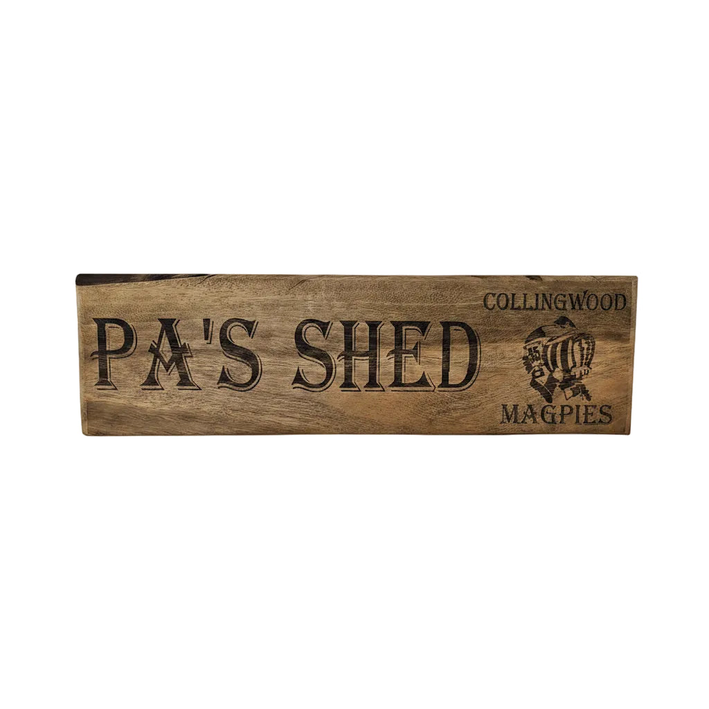 Wooden sign with 'Pa's Shed' and 'Collingwood Magpies' branding.