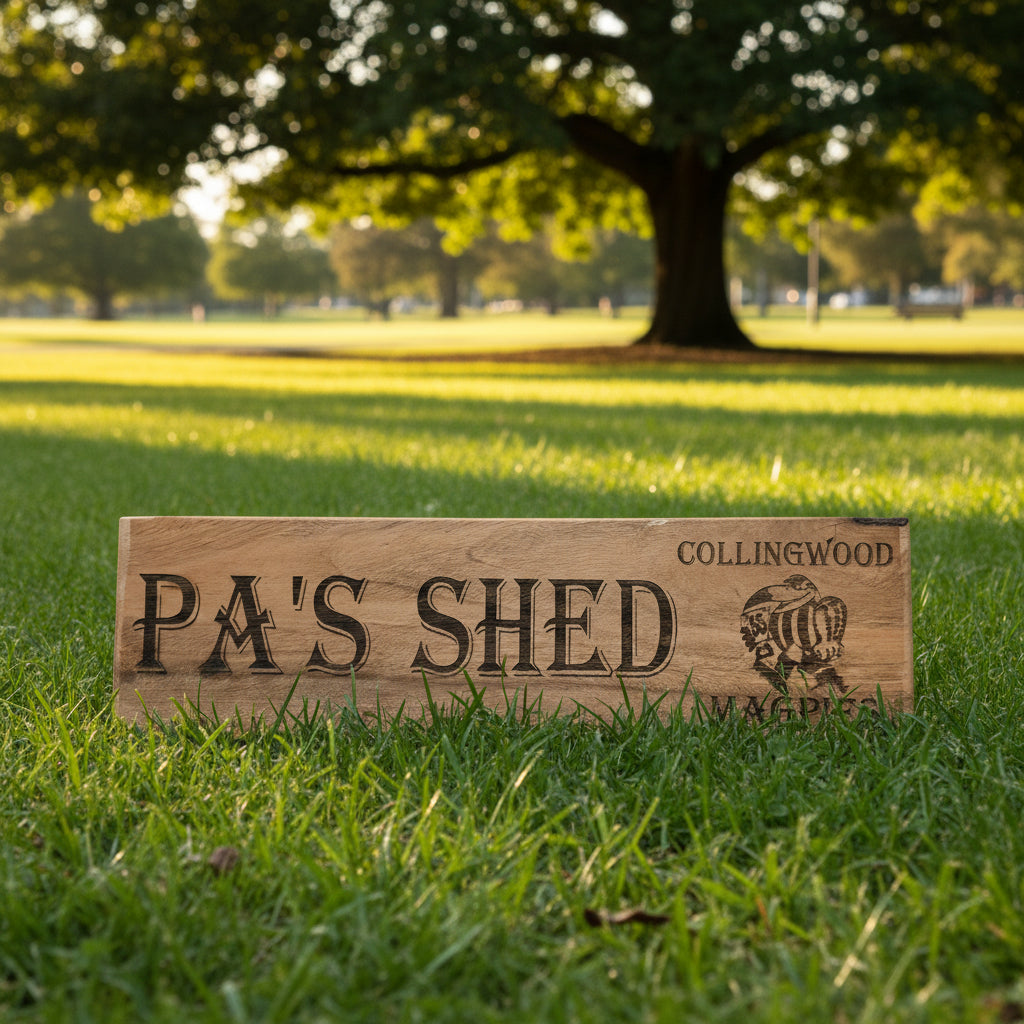 Wooden sign with 'PA'S SHED' and 'Collingwood Magpies' branding.